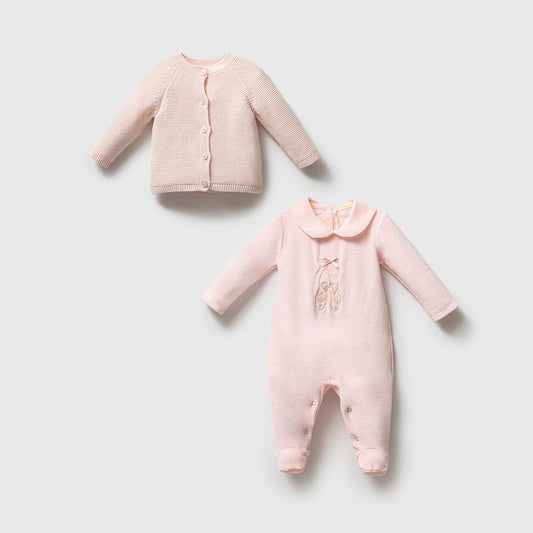 Pink baby cardigan and onesie on a light gray background