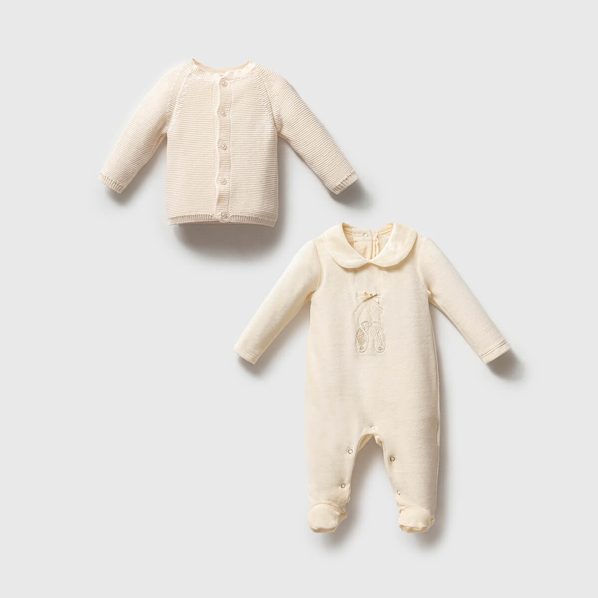 Baby outfit with a jacket and overallon a light gray background