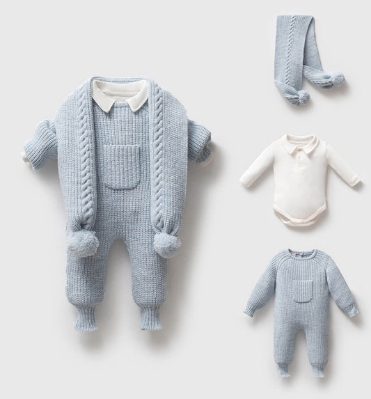Knitted baby romper with matching scarf and onesie on a light gray background