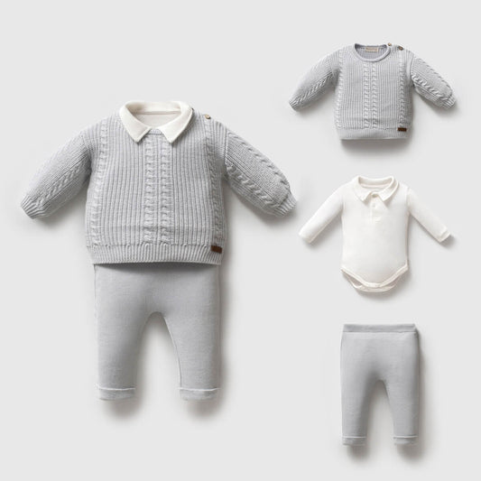 Baby clothing set with sweaters, pants, and a onesie on a light gray background