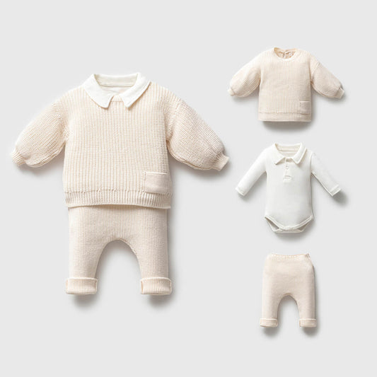 Set of baby clothing including a sweater, pants, and a onesie 